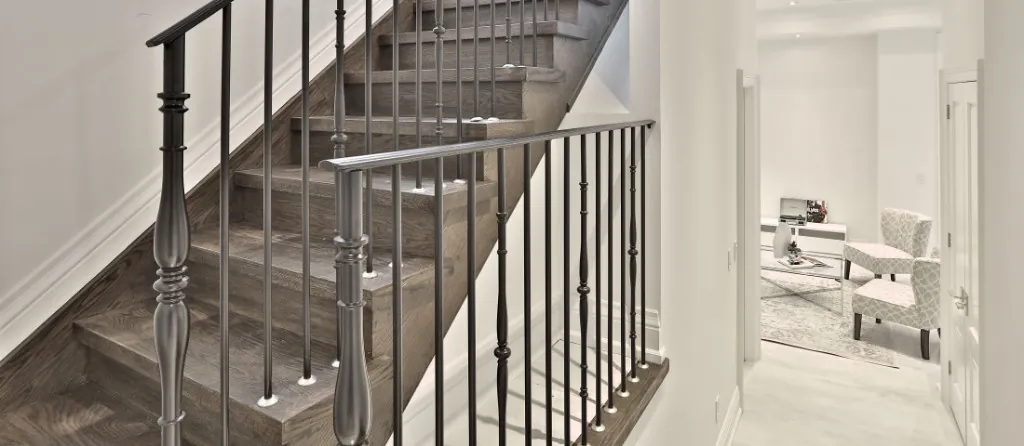 Finished basement staircase with dark wood treads and wrought iron railing in Davisville Village, Toronto