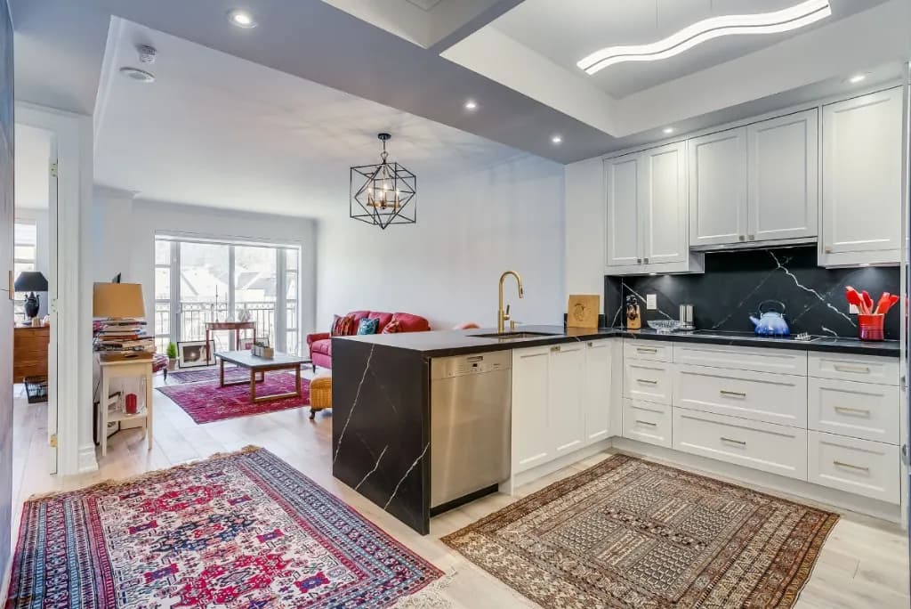 Open-concept condo renovation with waterfall island in Midtown, Toronto