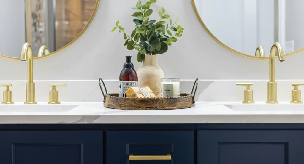 Luxury bathroom vanity with navy cabinetry and gold fixtures in Toronto